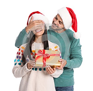 Young man giving gift box to his girlfriend. Christmas celebration