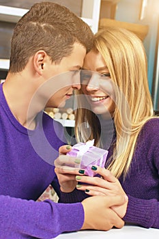 Young man giving a gift to his girlfriend