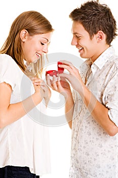 Young man giving his girlfriend ring