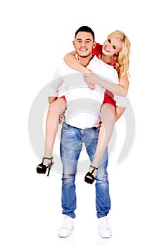 Young man giving piggyback to his girlfriend