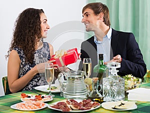 Young man giving present to beautiful woman