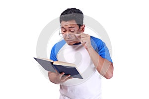 Young Man With Glasses Having Bad Vision When reading Book