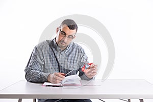 Young man with glasses holding notebook and