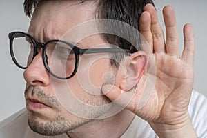 Young man with glasses is listening to you carefully