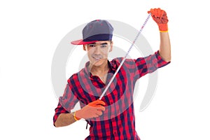 Young man in gloves and snapback holding tape-measure