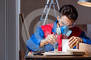 The young man gluing wood pieces together in diy concept