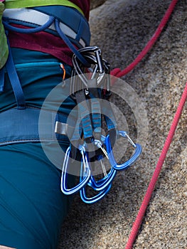 Young man go to climb on the rock with a bell