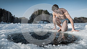 Young man going to swim in an ice hole