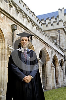 A young man in a graduation gown.