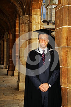 A young man in a graduation gown.