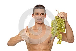 Young man with grapes