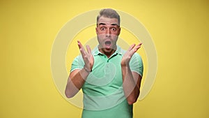 young man in green polo shirt in studio