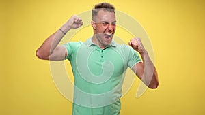 young man in green polo shirt in studio