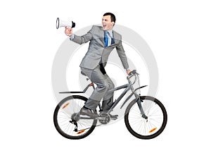 Young man in grey business suit on bike