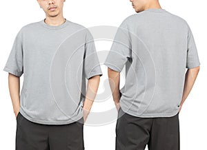 Young man in grey oversize t-shirt mockup front and back used as design template, isolated on white background.