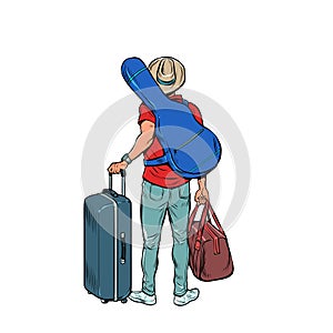 a young man with a guitar is a traveler flying on tour, luggage at the airport. Creative trip