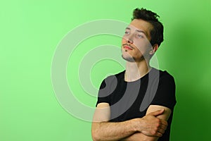 Young man or guy on a light green background. The emotion of calm and serenity