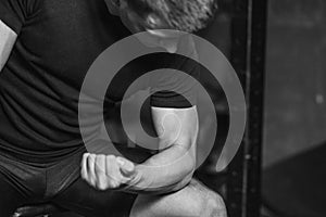 Young man in the gym. Healthcare. Lifestyle. A sexy man dressed in a black T-shirt. Caucasian Bodybuilder is nourished