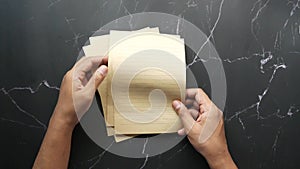 young man hand on blank paper on table