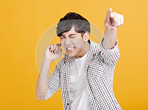 Young  man with hand cover his ear  and pointing forward