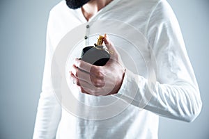 Young man hand holding perfume