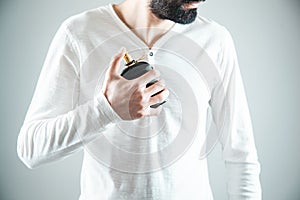 Young man hand holding perfume