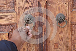 young man hand knocking door,