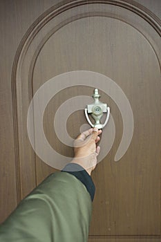 young man hand knocking door,