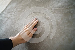 Young man hand touching concrete wall photo