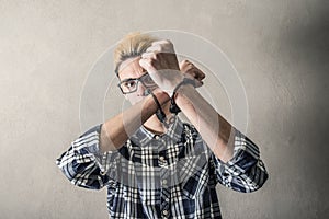 Young man with handcuffs at the wrists photo