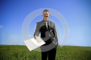 Young man handing a folder