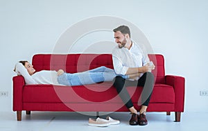 Young man hands giving massage to woman foots on red sofa,foot soles massage