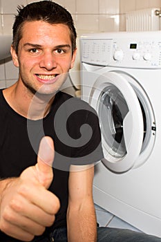 Young man happy with washing mashine