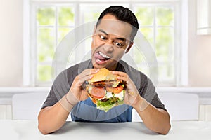 Young Man have a great desire to eat a burger