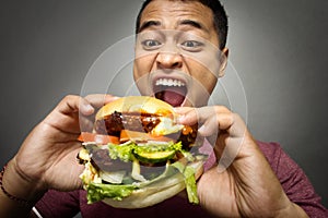 Young Man have a great desire to eat a burger