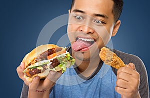 Young Man have a great desire to eat a burger