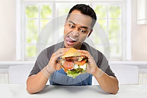 Young Man have a great desire to eat a burger photo