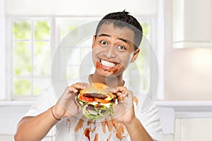 Young man have a great desire to eat a burger