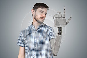 Young man have robotic hand as a replacement for his hand. 3D rendered illustration of hand