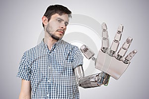 Young man have robotic hand as a replacement for his hand. 3D rendered illustration of hand