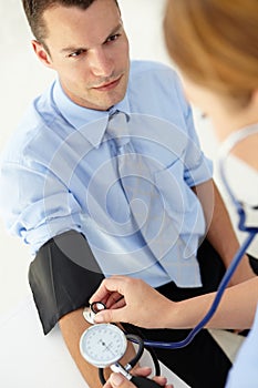 Young man having blood pressure taken