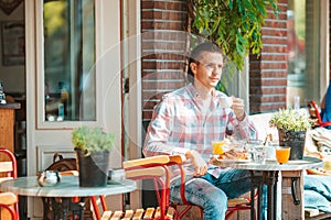 Man having breakfastin outdoor restaraunt photo