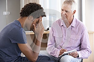 Young Man Having Counselling Session photo