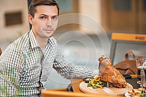 Young man having dinner in outdoor restaraunt.