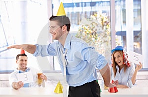 Young man having fun at office party