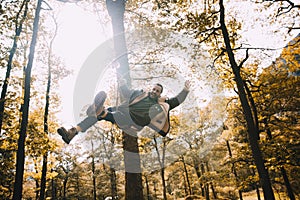 Young man Having fun on a Rope Swing