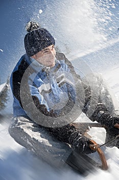 Young man having fun with sled