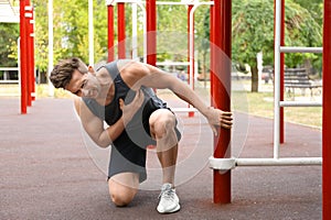 Young man having heart attack on ground