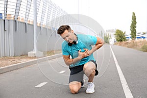 Young man having heart attack while running