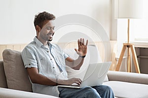 Young man having meeting online. Student men using laptop computer at home